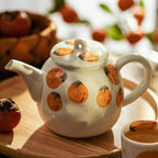 Teapot and Orange Cups