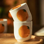 Teapot and Orange Cups