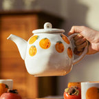 Teapot and Orange Cups