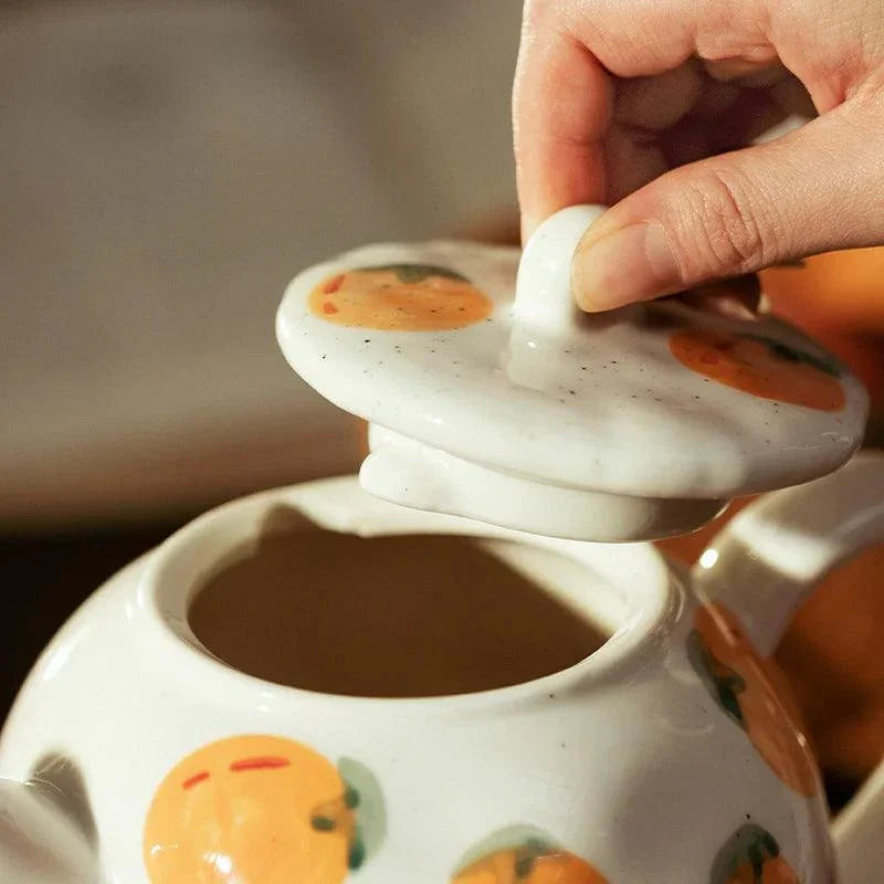 Teapot and Orange Cups